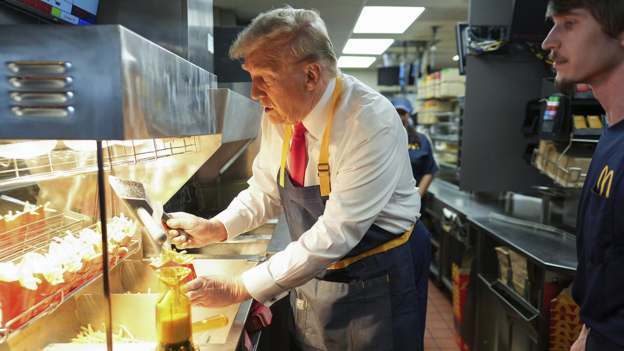 Donald Trump’s stunt serving fries as at McDonald's made headlines around the world and he used the opportunity to cast doubt on his opponent’s employment history. Picture: Doug Mills/The New York Times via AP/Pool