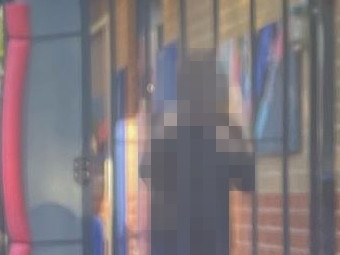 A child in seclusion, behind a locked gate and bars in a NSW school.