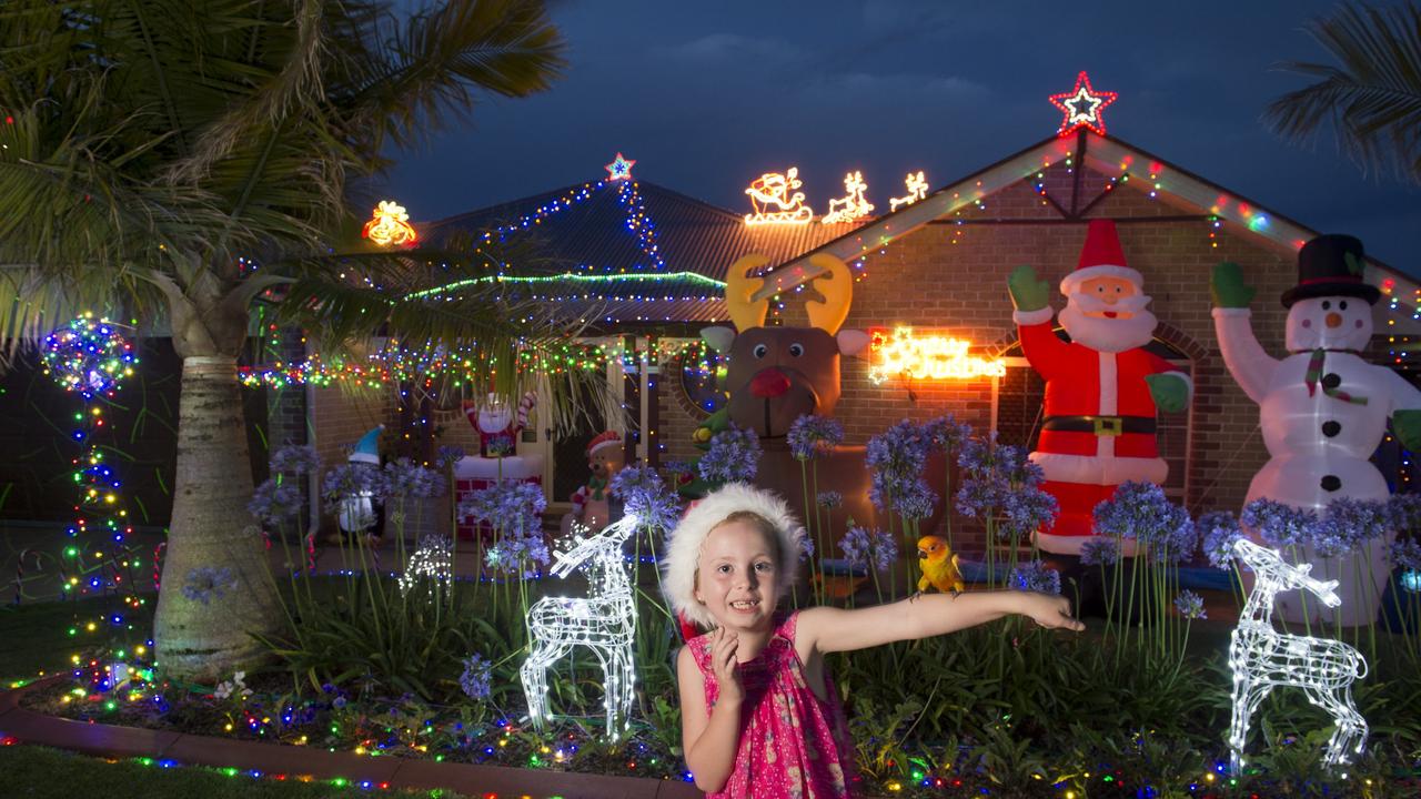 Zahli Eade with her sun conure parrot Binky outside her family's Prime Minister Dr home entered in the first time entered category of Toowoomba Christmas Lights Competition, Friday, December 11, 2015. Photo Kevin Farmer / The Chronicle