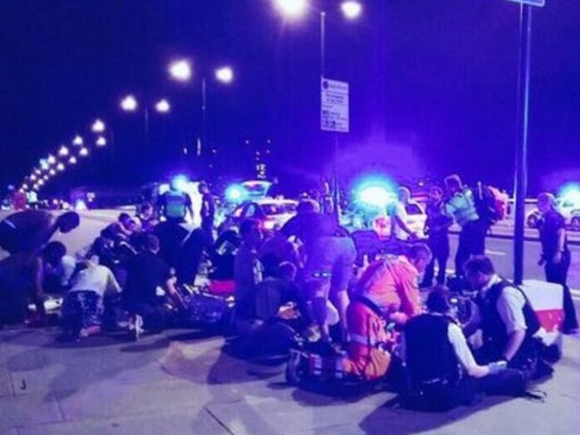 Emergency services and bystanders rush to help people hit by the van on London Bridge.