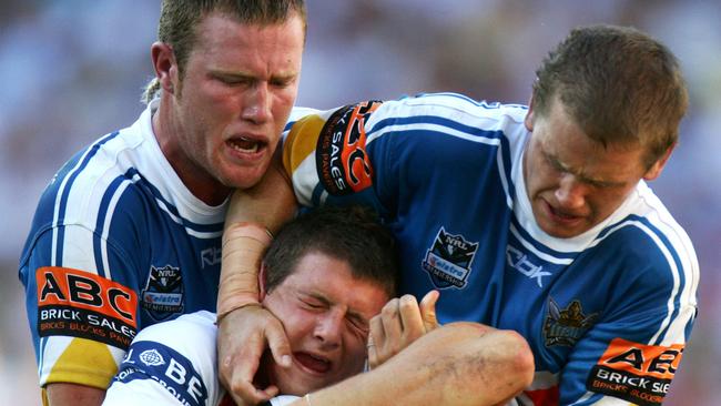 Matt Hilder and Gavin Cooper in action for the Titans’ first NRL game. Image: Darren England