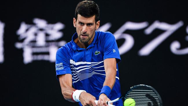 Advertising aimed at the Chinese market serves as a backdrop to Novak Djokovic.