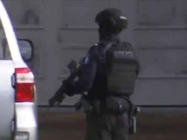 Queensland Police are negotiating with a wanted man locked inside a quiet suburban home on the Gold Coast. , , The major police operation began after officers swarmed a Marbella Drive home in Benowa Waters, Queensland, where it’s understooda wanted man is hiding out.  Picture: 7 News