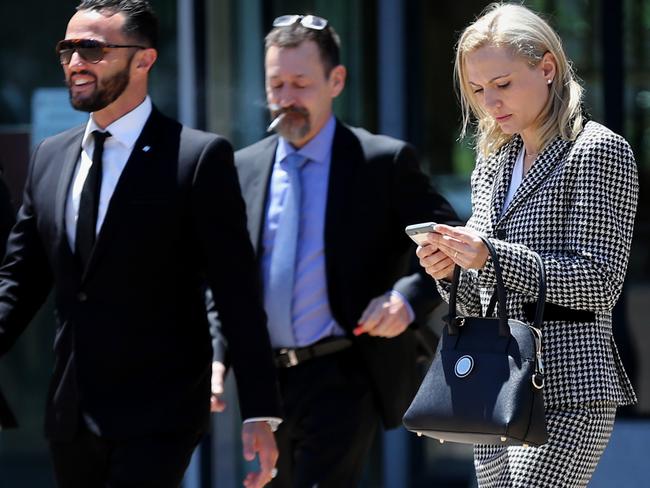 Clive Palmer's wife Anna takes a lunch break with an entourage from the High Court in Canberra today.