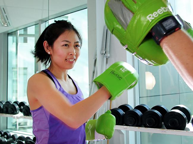 CMNEWS_Flight Centre staff members Chloe Pham and Jason Ruttley completing a gym session inside the company office personal gymnasium this afternoon Wednesday June 18, 2014. Pictures: Jack Tran / The Courier Mail