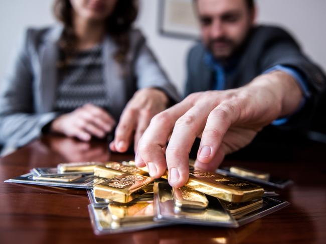 Employees organize mixed weight gold bars in this arranged photograph at Solar Capital Gold Zrt. in Budapest, Hungary, on Thursday, March 10, 2016. Gold advanced to the highest level in a year after the European Central Bank indicated it wouldn't cut interest rates further, boosting the euro and making dollar-denominated bullion less expensive for investors. Photographer: Akos Stiller/Bloomberg