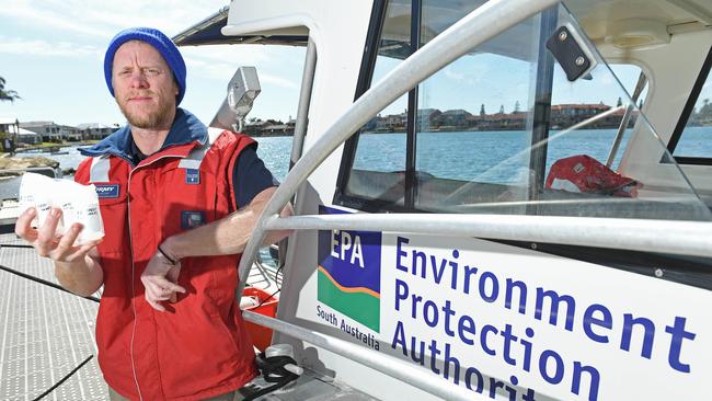 EPA principal scientific officer Sam Gaylard with water samples taken from West Lakes. Picture: Tom Huntley