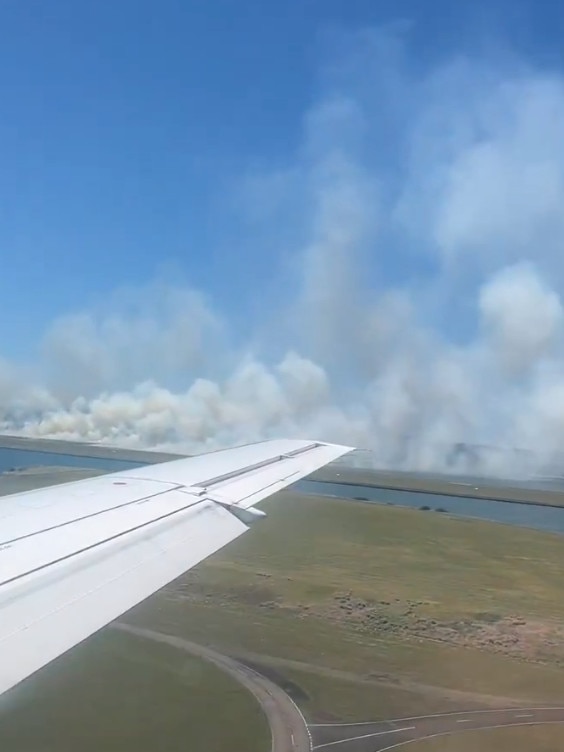 A grass fire has taken off next to the third runway at Sydney Airport. picture X