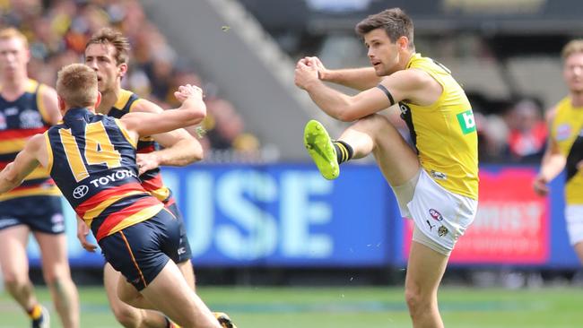 Trent Cotchin kicks the ball out of the middle. Picture: Alex Coppel