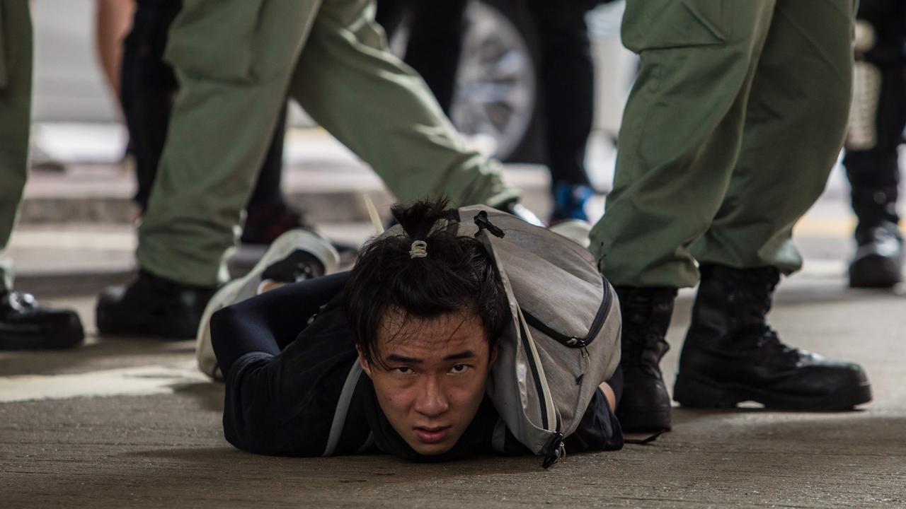 A man is detained in protests in Hong Kong on Wednesday. Picture: Dale De La Rey/AFP