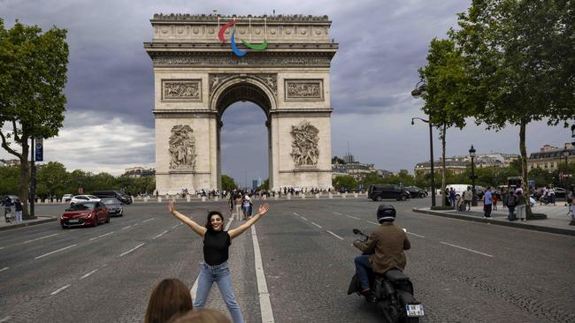 A visitor poses for a photo near the Arc de Triomphe. Picture: Getty Images