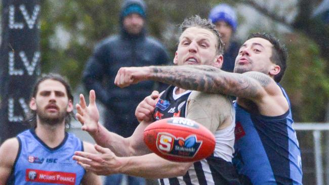 Port Adelaide Magpies’ Trent McKenzie is spoiled by Jake Sutcliffe. Picture: AAP/Brenton Edwards