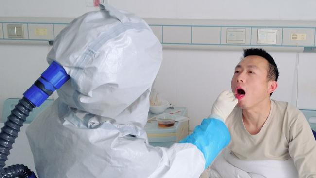 While quarantined in Shantou, Shen began each morning with a series of tests, conducted by medical staff swathed head-to-toe in protective gear. Picture: Shen Wufu/The Wall Street Journal