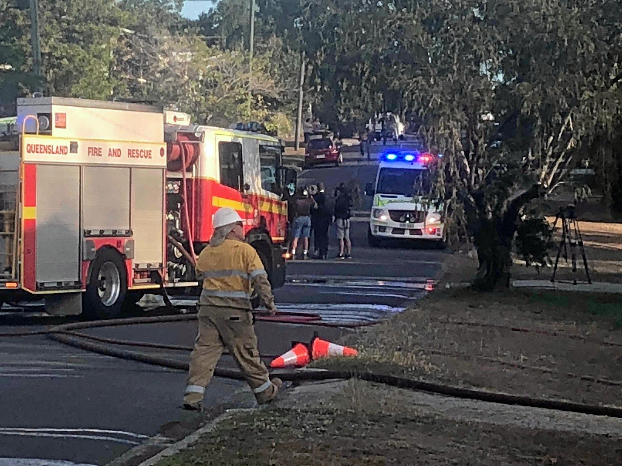 Firefighters at the scene of a house fire on Naughton St, Wandal, this afternoon. Reports indicate the top part of the house is gutted but firefighters are walking in through the front door.