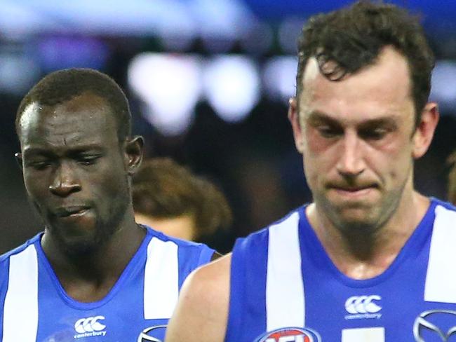 MELBOURNE, AUSTRALIA - JULY 09:  Majak Daw (L) of the Kangaroos leaves the field with Todd Goldstein of the Kangaroos and his teammates after losing the round 16 AFL match between the North Melbourne Kangaroos and the Fremantle Dockers at Etihad Stadium on July 9, 2017 in Melbourne, Australia.  (Photo by Scott Barbour/Getty Images)