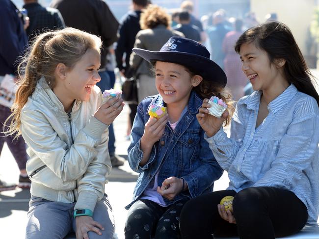 Charlotte Baumer-Rowley, Abigail Paki and Uma Astill enjoy the cake stalls at Neutral Bay Public School during the North Sydney Council Election. Pic: AAP Image/ Jeremy Piper