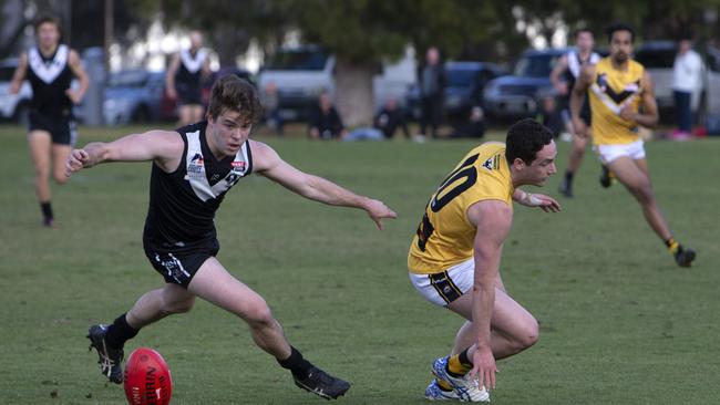 Adelaide University’s Hamish Wallace and Brighton’s Jack Plenty in action during the sides’ round seven Adelaide Footy league match at University Oval on Saturday. Picture: Emma Brasier