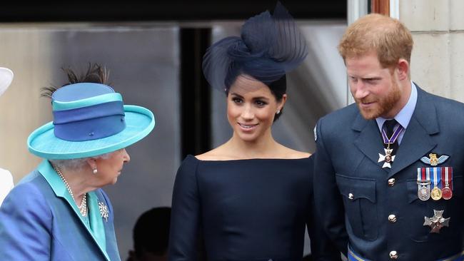 Queen Elizabeth, Meghan, Duchess of Sussex, Prince Harry, Duke of Sussex watch the RAF flypast on the balcony of Buckingham Palace. Picture: Getty