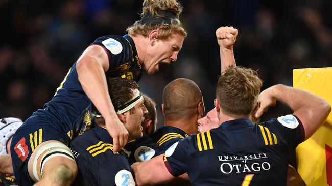 Highlanders flanker James Lentjes celebrates with teammates after victory in Dunedin.