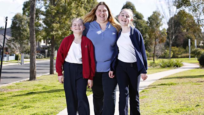 Rachael Mibus, 11, her sister Claire, 10, prefer to wear pants to school, which their mum Melissa wants to happen at all schools. Picture: Adam Yip