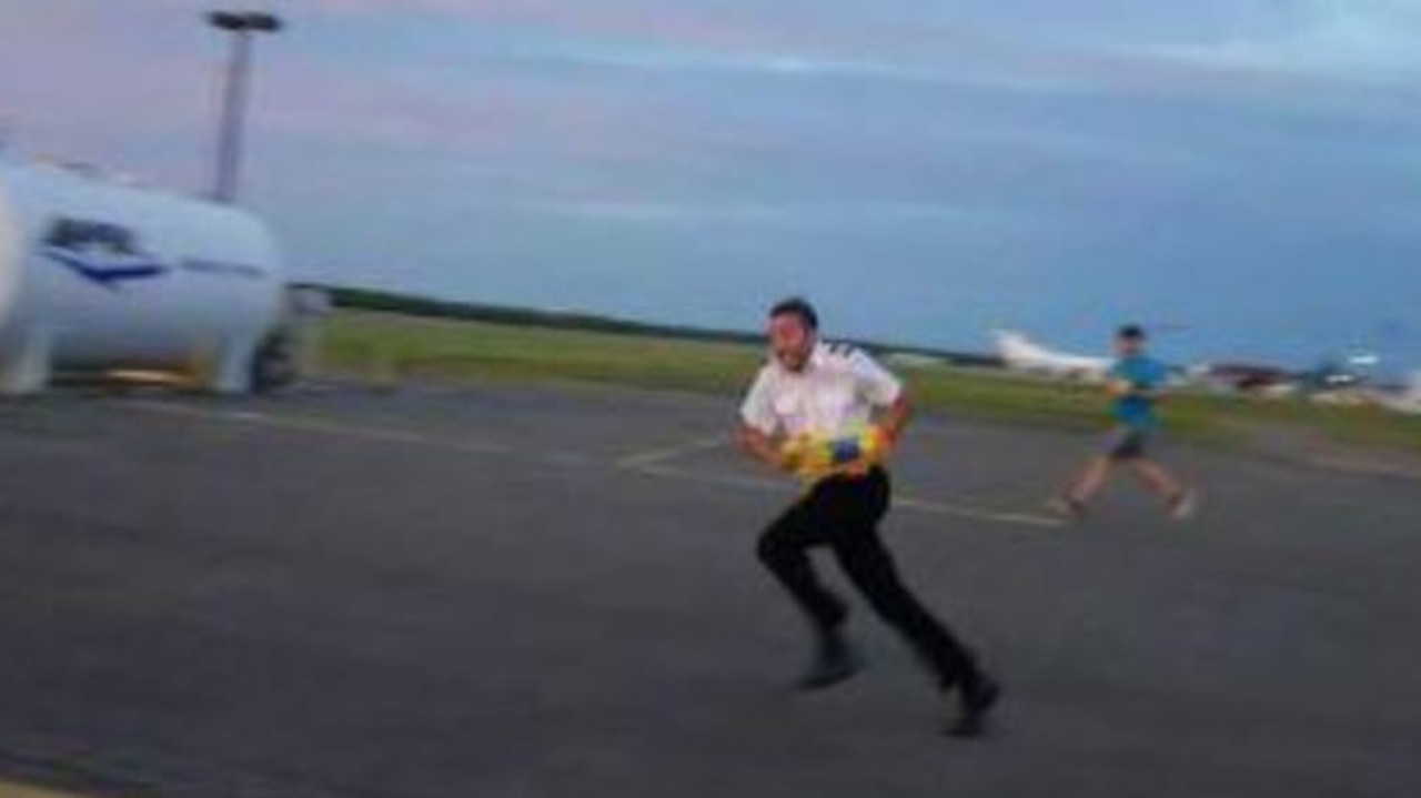 A traveller captured airline staff having water gun fights on the tarmac. It is hard to imagine a more delightful scene. Picture: Reddit