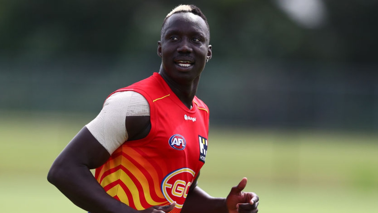 GOLD COAST, AUSTRALIA - MARCH 16: Mabior Chol runs during a Gold Coast Suns training session at Metricon Stadium on March 16, 2022 in Gold Coast, Australia. (Photo by Chris Hyde/Getty Images)