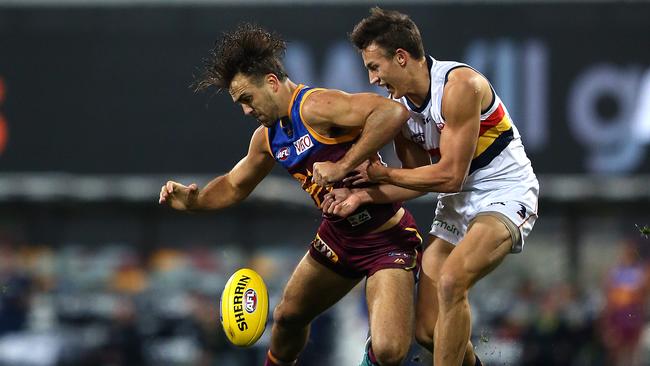 Rhys Mathieson of the Lions collides with Tom Doedee of the Crows at the Gabba. Picture: AAP Image/Jono Searle