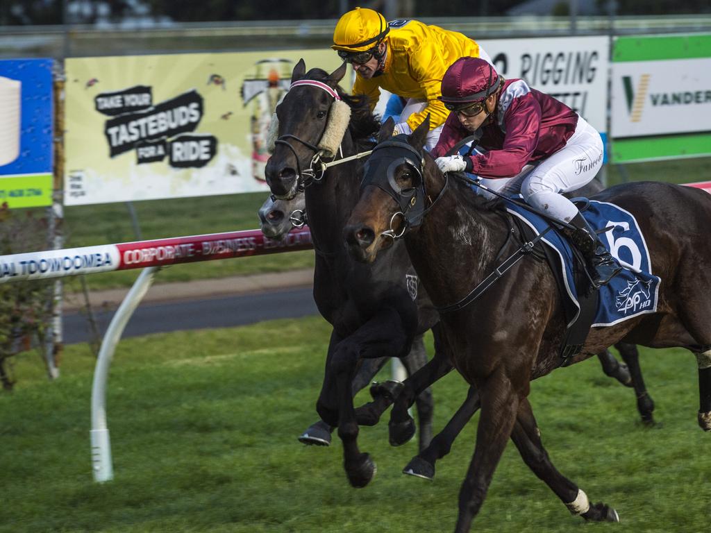 Jockey Alannah Fancourt guides Chevrons'n'rockers (outside) to win race one at Clifford Park Racecourse, Saturday, June 19, 2021. Picture: Kevin Farmer