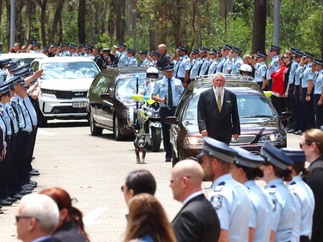 A hearse passes the guard of honour at the memorial service with full police honours for constables Rachel McCrow and Matthew Arnold at Brisbane Entertainment Centre. Picture: David Clark