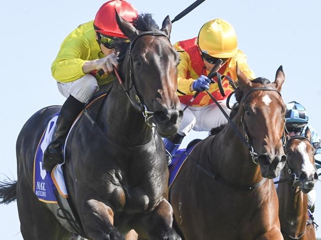 O' Ole (red cap) wins 2024 Magic Millions 2YO Classic from Memo (yellow cap), Horsehoe Hill (outside) and Tempestuous (rails) Picture: Bradley Photos