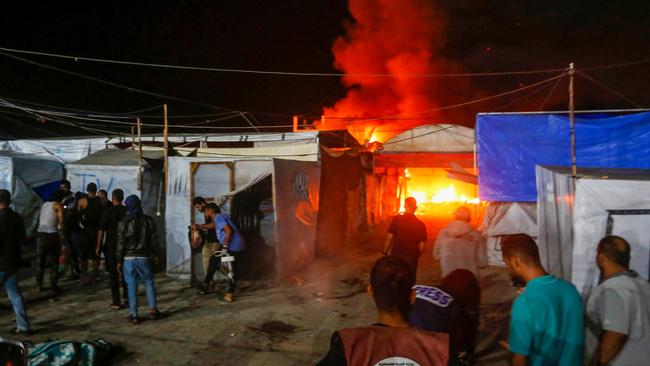 Fire and smoke among the tents in the courtyard of Al-Aqsa hospital. Picture: UNRWA/AFP =