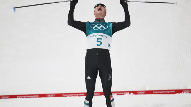 Sweet relief... Eric Frenzel of Germany celebrates as he crosses the line to win gold. Picture: Getty