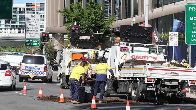 Workers shovel up manure that was dumped near Parliament House in Alice Street this week. Picture: Peter Wallis