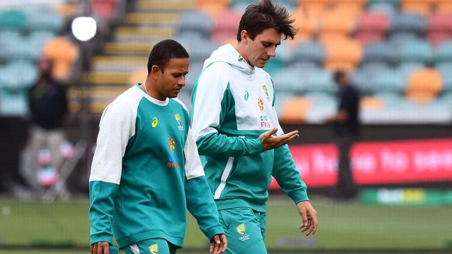 Australia's captain Pat Cummins and batsman Usman Khawaja chat before the start of the first day of the fifth Ashes cricket Test match against England in Hobart on January 14, 2022. Picture: William West/AFP