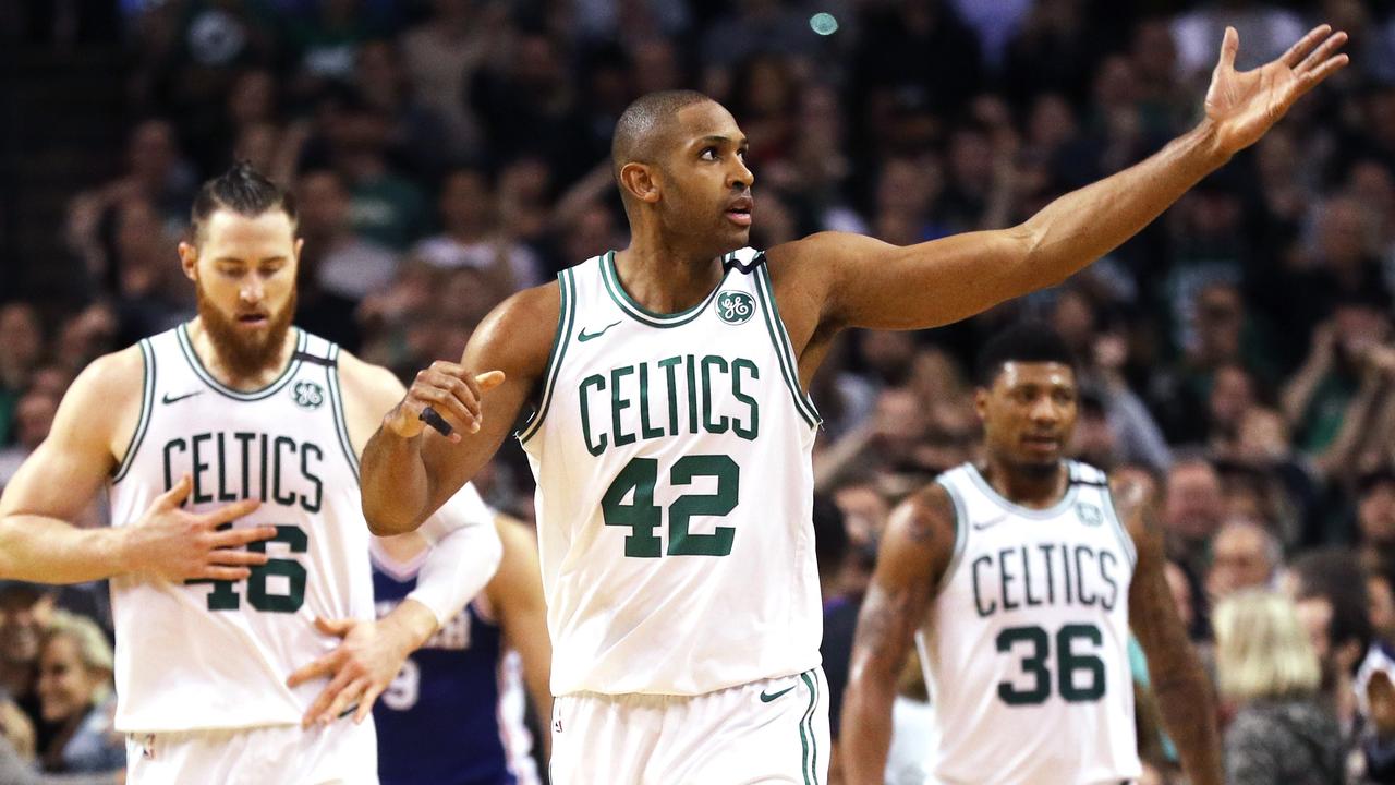 Al Horford of the Boston Celtics signals to fans at TD Garden.