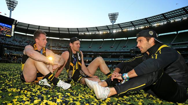 Dylan Grimes, David Astbury and Alex Rance soak up the Tigers’ flag long after the siren. Picture: Mark Stewart