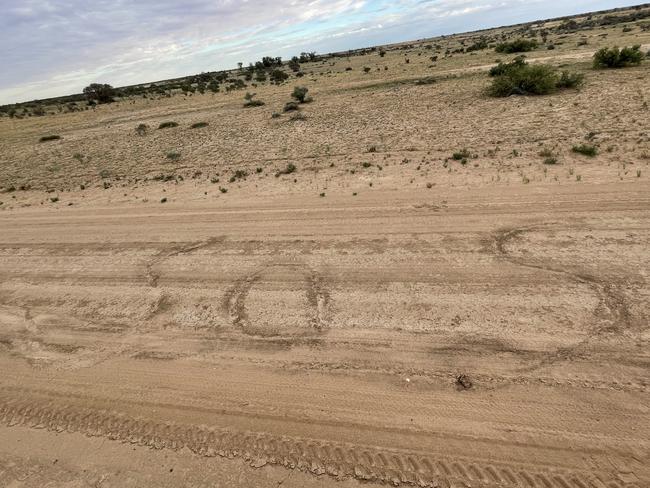 Lost tourists: The pair scratched several SOS signs by the, roadside before they were found near Innamincka.