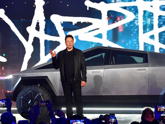 (FILES) Tesla co-founder and CEO Elon Musk introduces the newly unveiled all-electric battery-powered Tesla Cybertruck at Tesla Design Center in Hawthorne, California on November 21, 2019. US automaker Tesla on July 15, 2023, announced that its first electric pickup -- a slick-looking silver Cybertruck -- had rolled off the assembly line at its huge plant near Austin, Texas. 