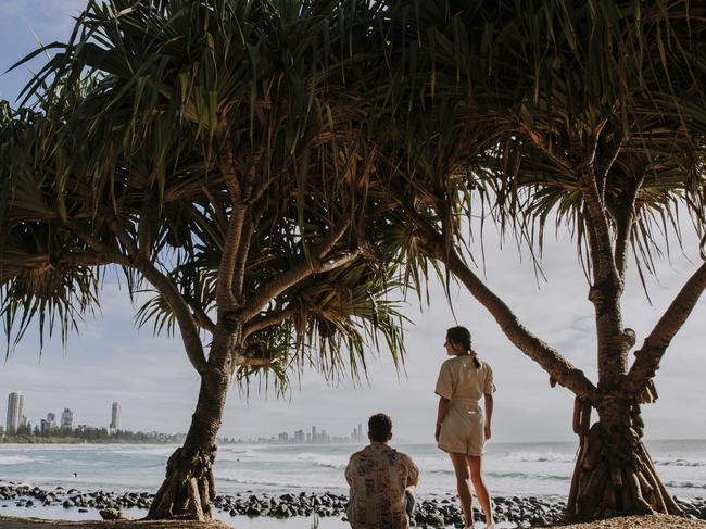 Couple watching the waves with Surfers Paradise on horizoncredit: Jack Harlem/Tourism QLDescape14 february 2021neighbourhood burleigh heads