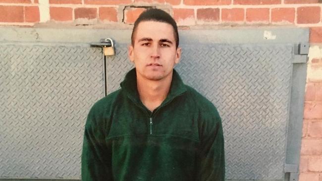 Rapper and author Spanian in green prison uniform when he "graduated" to adult prisons. Picture: Supplied/Spanian