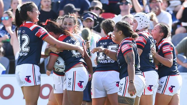 Yasmin Meakes celebrates with teammates after scoring a try