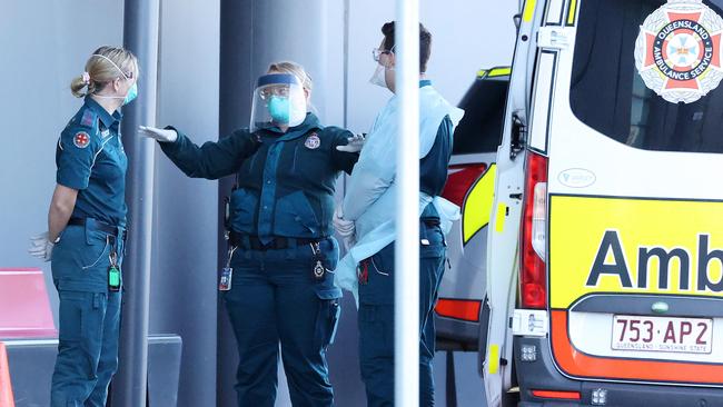 Ambulance and police in PPE and masks at the Novotel Brisbane Airport. Picture: Liam Kidston