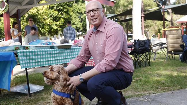 Peter Dutton with the family dog Ralphie as he attended an informal Easter Sunday BBQ in Ipswich. Picture: Richard Dobson / NewsWire