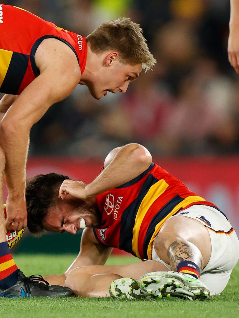 Lachlan Murphy holds his neck after the tackle. Picture: Michael Willson/AFL Photos via Getty Images