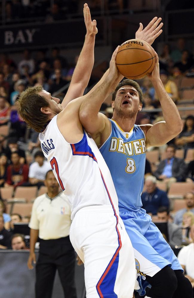 Danilo Gallinari #8 of the Denver Nuggets shoots against Joe Ingles #7 of the Los Angeles Clippers during their preseason game.