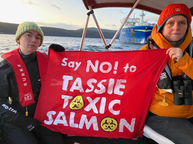 Environmentalists prevent a large Tassal ship from releasing salmon into Long Bay on Tuesday morning.