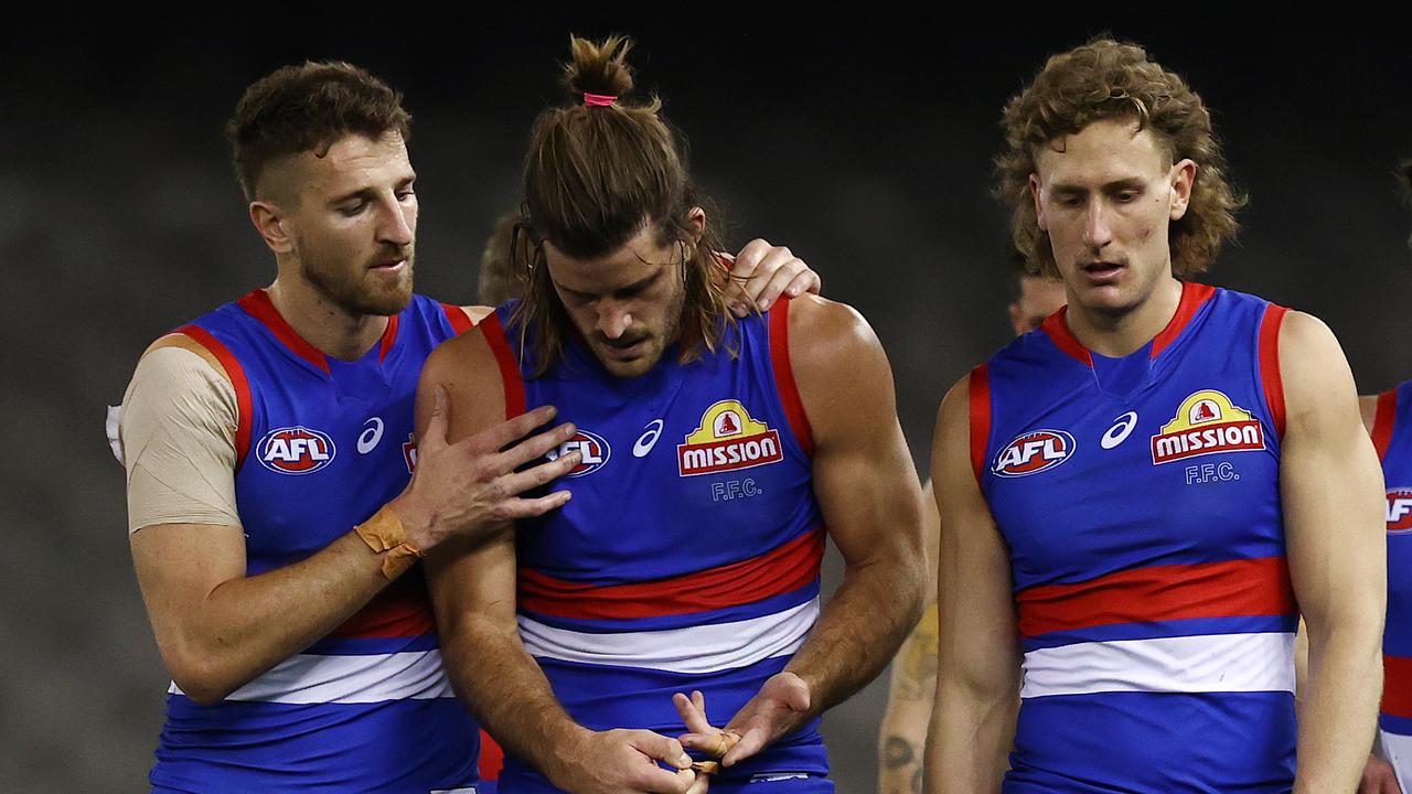 Josh Bruce is consoled by Marcus Bontempelli after being injured.