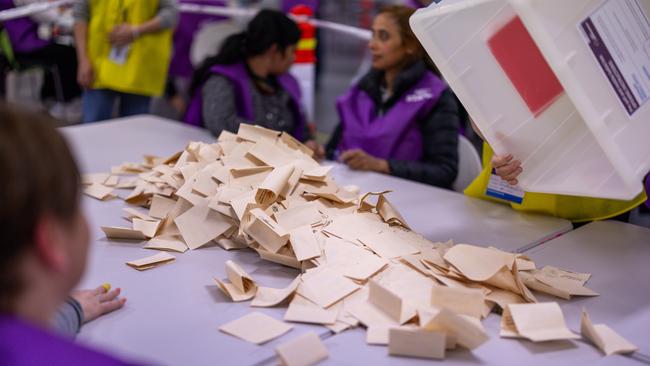 Ballot papers are placed onto a table prior to being counted a vote counting centre in Melbourne.