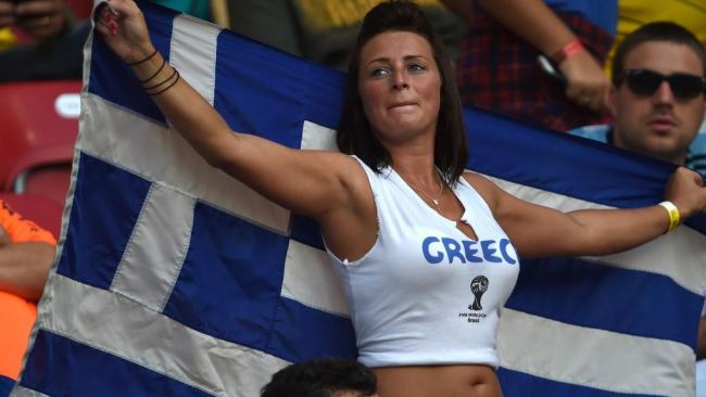 This woman just wanted to cheer her country on, but she instead found herself at the end of a photographer's lens. Picture: Herald Sun