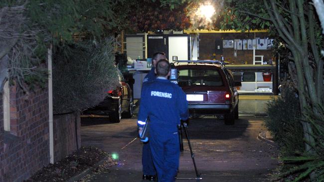 Police at the scene where Terry and Christine Dodson were murdered in their Kew East home.